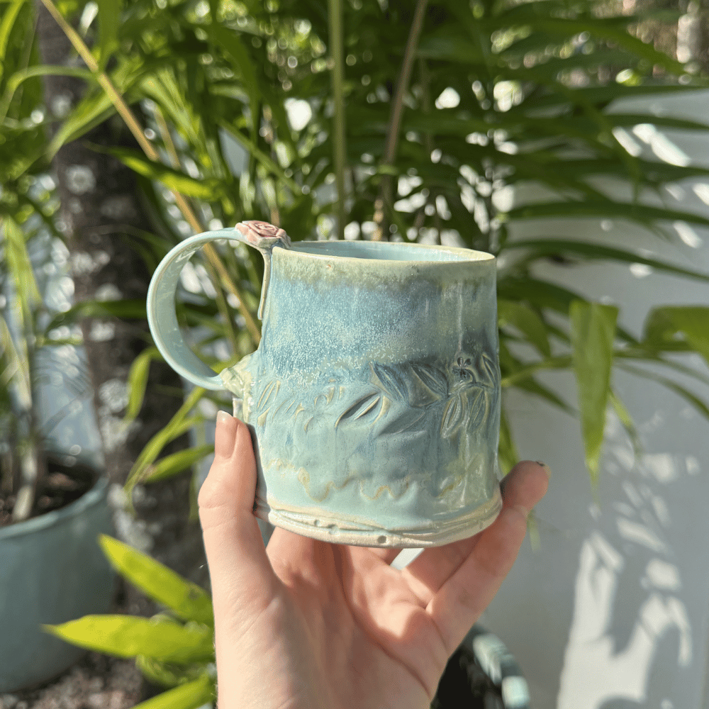 artisan pottery mug green glaze floral handle